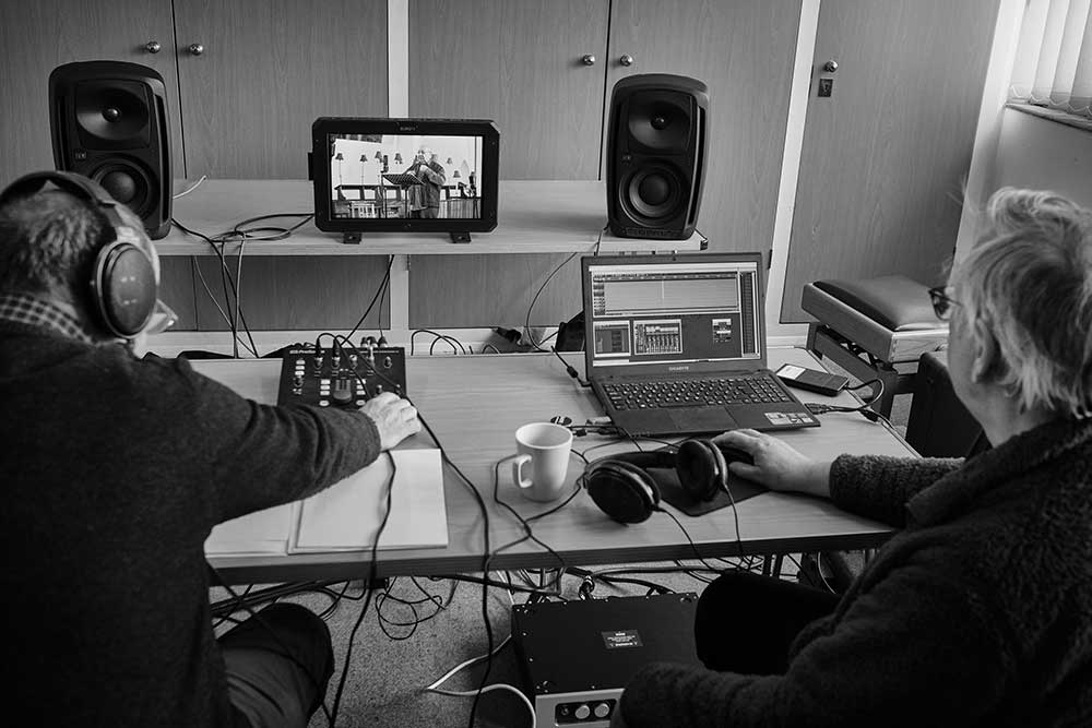 Tony Halstead (in the monitor) recording the poems. Mike Purton and Tony Faulkner in the control room.